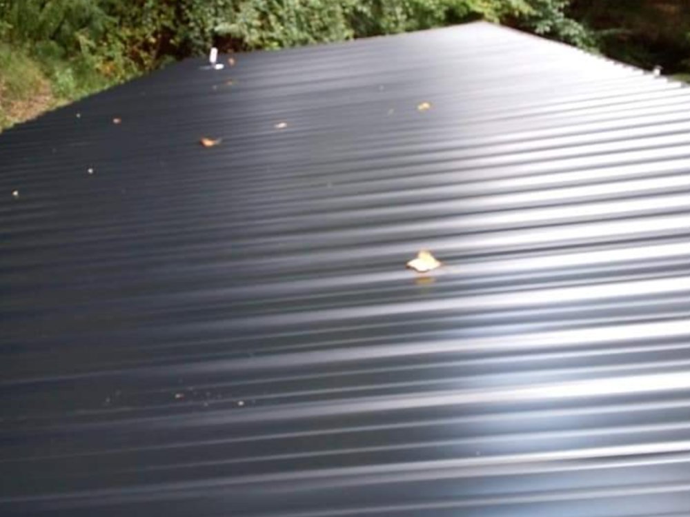 A newly installed dark corrugated metal roof, showcasing roofing services by Huntington Home Repair in Huntington, WV.