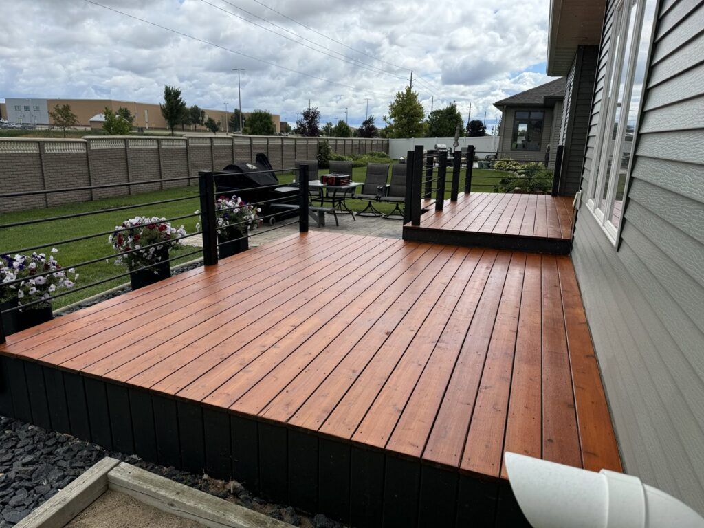 Newly constructed and stained outdoor deck by Midwest Handyman LLC in West Fargo, ND.