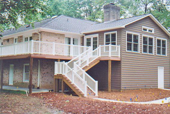 A newly constructed outdoor deck with elegant white railings, built by Tim Moss & Sons Home Improvement in Greensboro, NC.