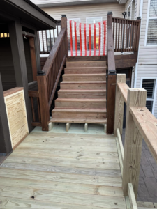 Newly constructed wooden deck stairs by Top Gunn Family Construction in Truxton, MO.