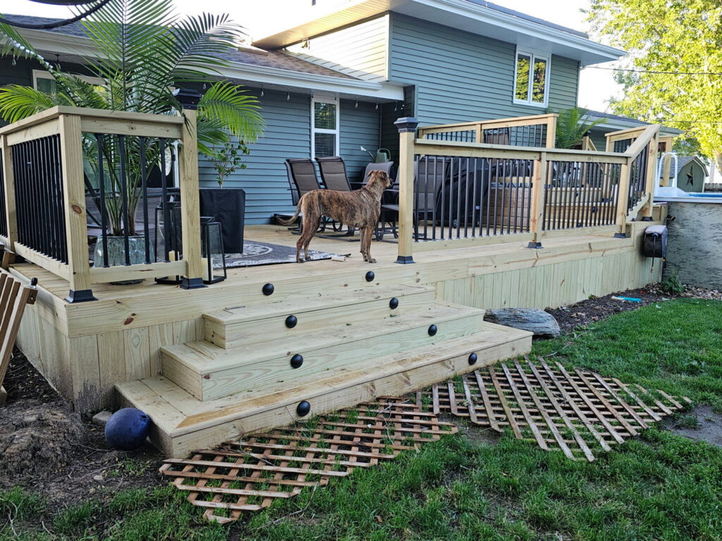 A newly constructed outdoor deck with stairs and railings, ready for enjoyment, built by Midwest Home Remodeling & Design LLC in Chicago, IL.