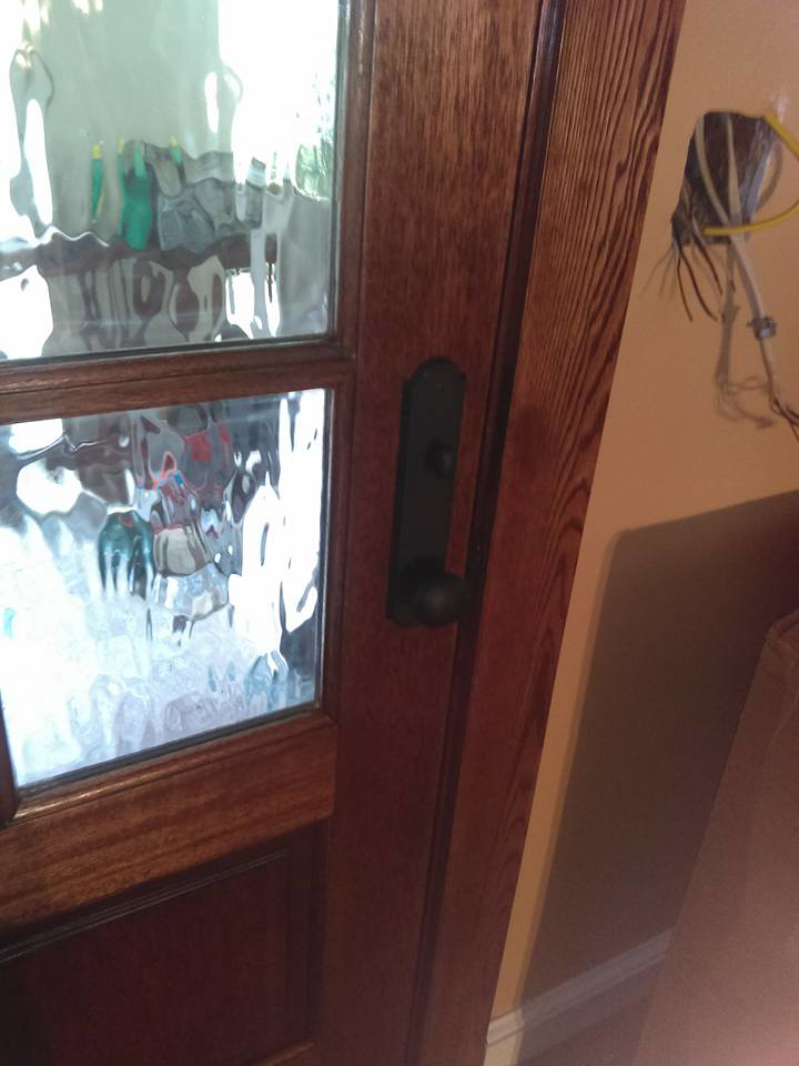 Close-up of a new door handle and lock being installed on a wooden door by Fryes Renovation and Improvements in Johnson City, TN.