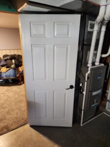 A newly installed white interior door by HandyMation in a home in Cheyenne, WY