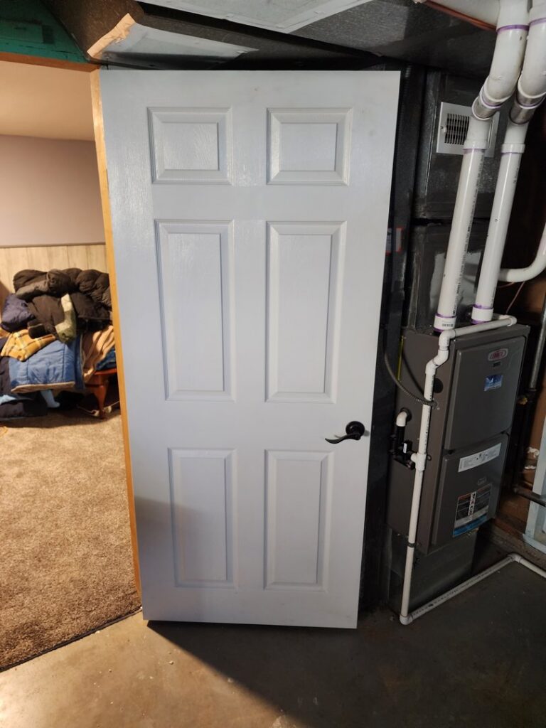 A newly installed white interior door by HandyMation in a home in Cheyenne, WY