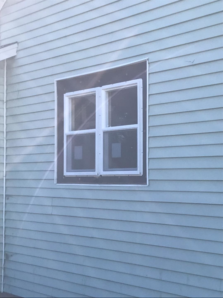 New double-pane window installation on a house exterior by Choice Contractors LLC in Fort Wayne, IN.