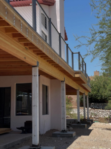 A newly constructed elevated deck with modern cable railings by Raven Construction LLC in Tucson, AZ.