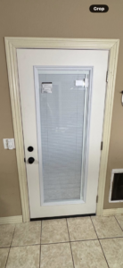 A newly installed white exterior door with integrated blinds, a service by Screw it, Call Rod in Rogers, AR.