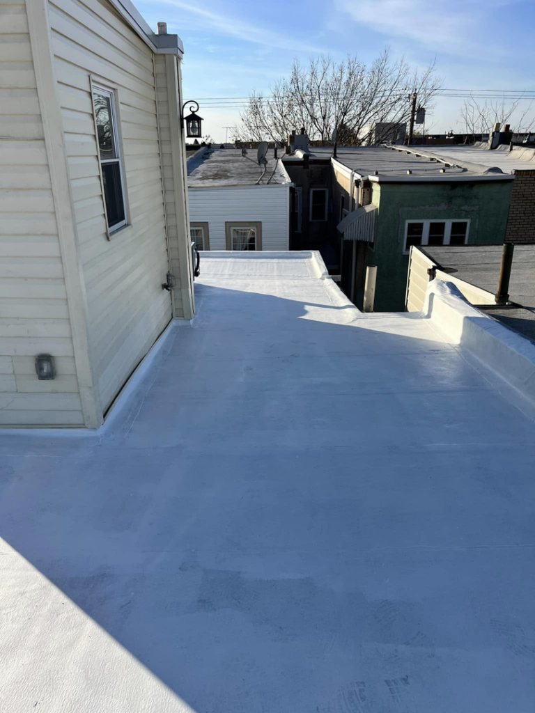 A newly applied white coating on a flat roof by DunnWright Contractor in Pensacola, FL.