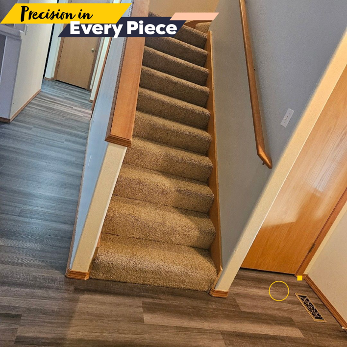 New flooring installed in a hallway next to a carpeted staircase by Dany's contractors LLC in Vancouver, WA.