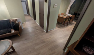 Newly installed light wood-look flooring in a living and dining area by RC Handyman Services in Council Bluffs, IA.