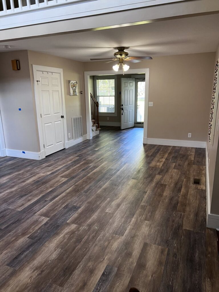 Newly installed flooring and painted walls in a room by Iron Horse Handyman Services LLC in Laramie, WY.