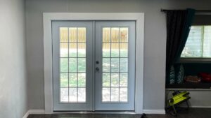 Interior view of a room with newly installed French doors leading to the backyard by Brewer Builds in Fort Worth, TX.