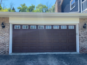 New garage door with siding and trim installation by Sockett Siding, LLC in Milwaukee, WI