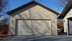 A newly sided garage with a new garage door installed by Chavez Contractor, LLC in St. Louis, MO.
