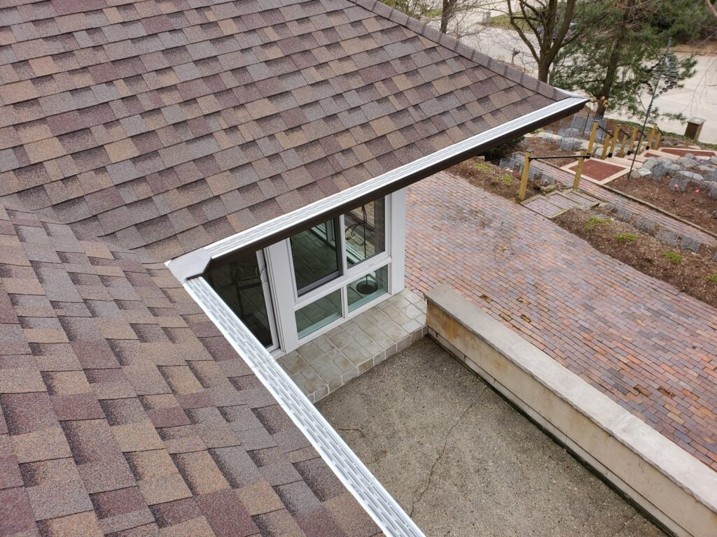 Newly installed gutters and gutter guards on a residential roof by Gutter Flow7 LLC in Madison, WI.