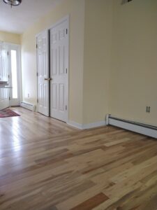 A room with newly installed hardwood flooring and light yellow walls by Brothers Home Improvement in East Hartford, CT
