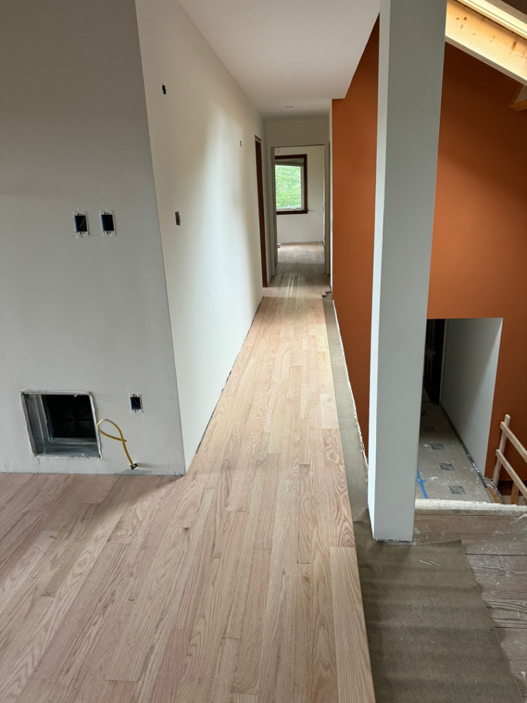 Newly installed light hardwood floor in a hallway by International Wood Floors in Gaithersburg, MD