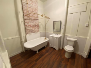 A room with newly installed hardwood flooring and intricate woodwork by Contollo Field Services in Pueblo, CO