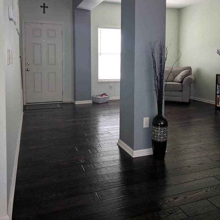 A newly installed dark hardwood floor in a hallway, showcasing quality flooring services by Berling Remodeling llc in Highland Heights, KY.