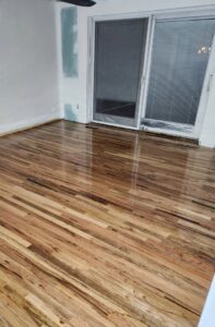 Newly installed hardwood flooring and drywall work in a room by Joe's Handyman Solutions in Ogden, UT.