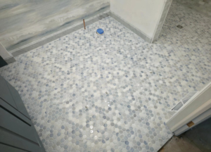 A newly installed hexagonal tile shower floor by Tyler the Tiler in Jefferson, WI.