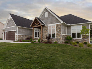 A beautifully completed new home construction featuring stone and siding exterior by Elk Building Services in Toledo, OH.