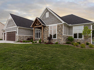 A beautifully completed new home construction featuring stone and siding exterior by Elk Building Services in Toledo, OH.