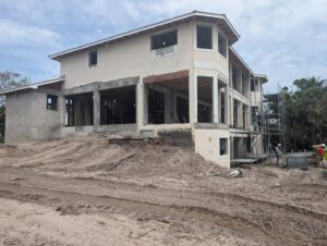 New home construction showing exposed framing and block walls, a project by Rock's Custom Homes in St. Petersburg, FL.