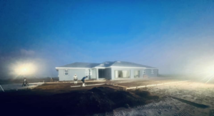 An early morning view of a new home construction site with workers by Cogdill Builders of Florida in Tampa, FL.