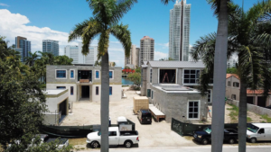 An aerial view of a new home construction site with two houses in progress by Intelligent Construction Inc. in Miami, FL.