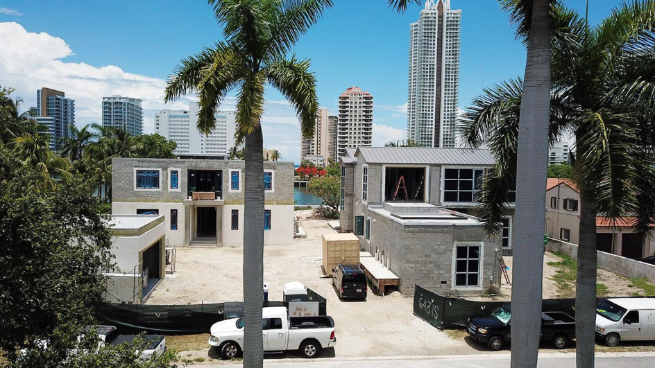 An aerial view of a new home construction site with two houses in progress by Intelligent Construction Inc. in Miami, FL.