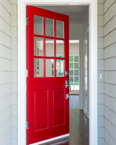 A new home's red front door and white siding, part of a project by Pigliavento Associates, LLC in Schenectady, NY.