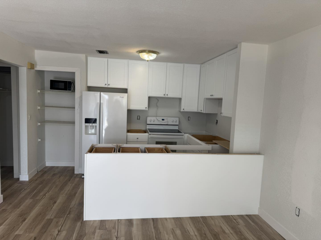 New white kitchen cabinets and appliances installed in a home under construction by Bradford Brothers Builders Inc. in Cape Coral, FL