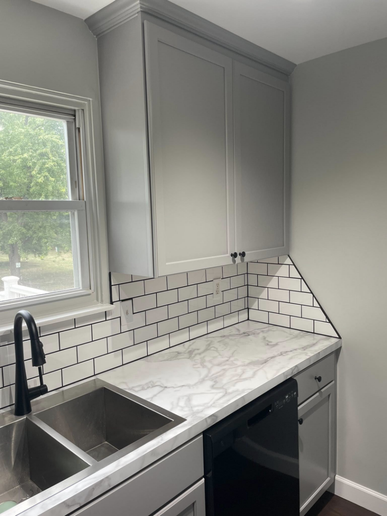 Close-up of a newly installed kitchen faucet and sink in a renovated kitchen by Wareham Home Improvements in Frederick, MD.