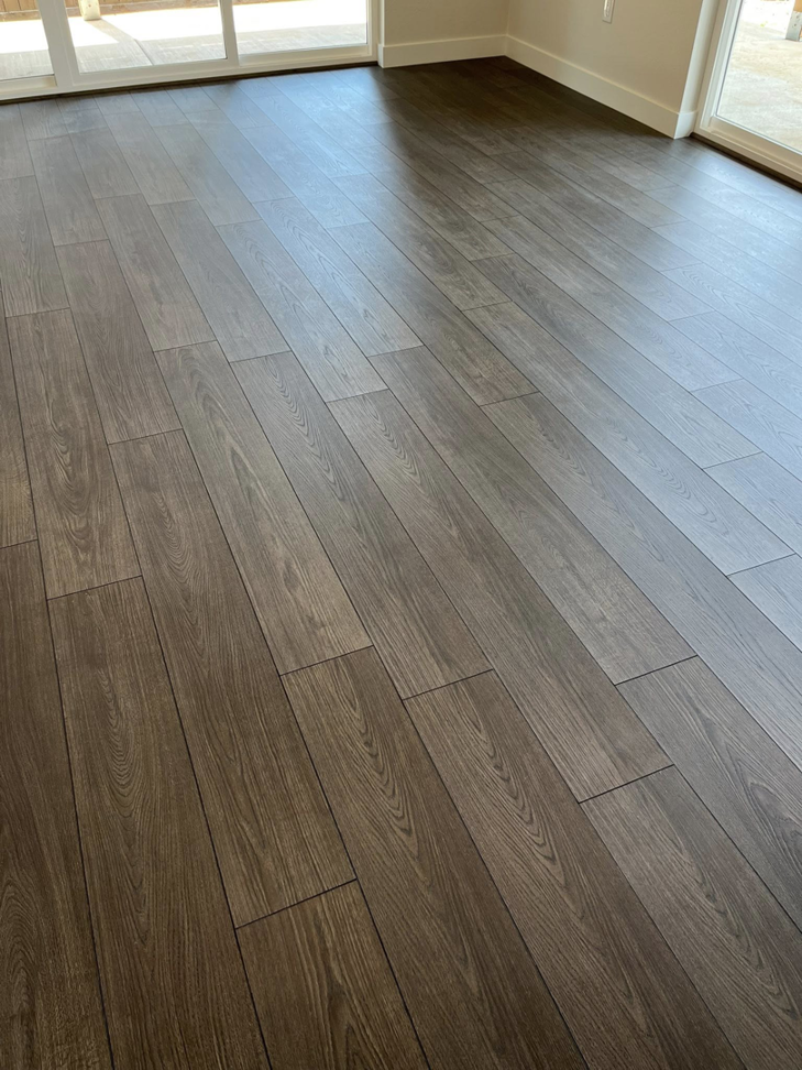Newly installed laminate flooring in a room by Denn Construction, Inc. in Medford, OR.