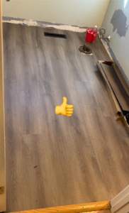 Newly installed laminate flooring in a room, showcasing a completed project by SGT. Handyman services RI in Downtown Pawtucket, RI