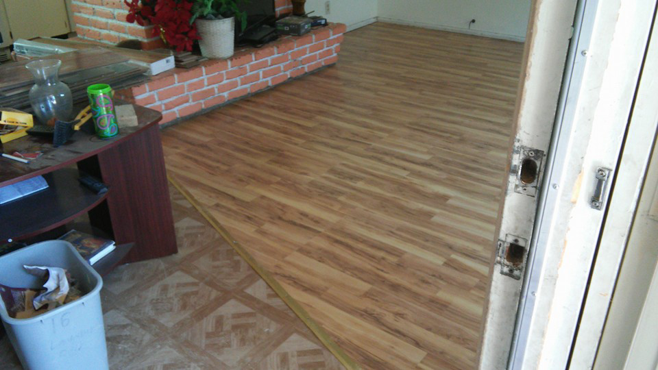Newly installed laminate flooring in a room, demonstrating flooring services by TNT Handyman Services LLC in Sparks, NV.