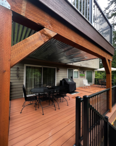 A newly built multi-level deck with an under-deck corrugated metal ceiling by Rosas Construction and Renovation in Dallas, TX.
