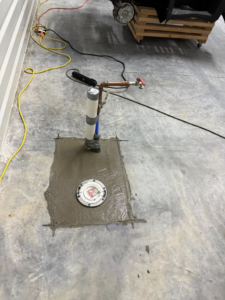 A newly installed outdoor faucet and drain with concrete patching by The General Handyman in Los Angeles, CA.