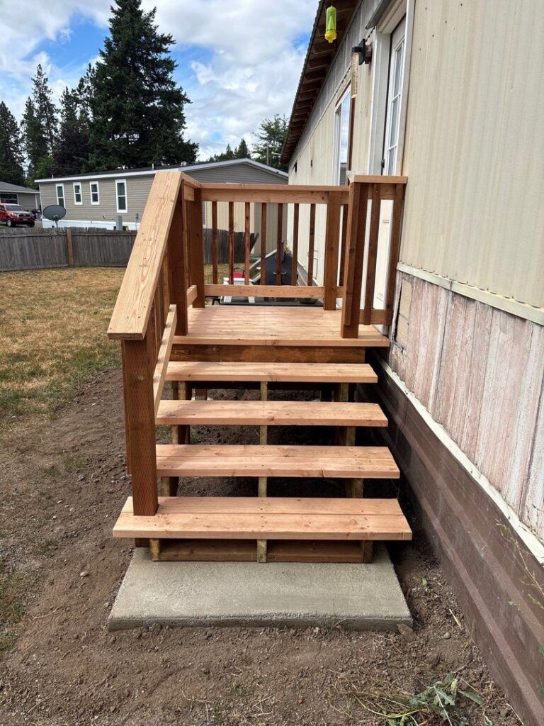 New outdoor wooden stairs construction for a mobile home by Panhandle Contracting Co. in Rathdrum, ID