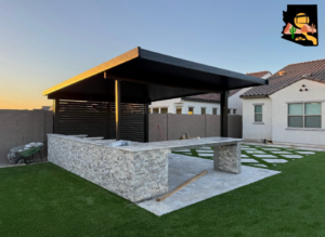 A newly constructed black patio cover and outdoor kitchen with stone facade by Az Sun Covers in Glendale, AZ.