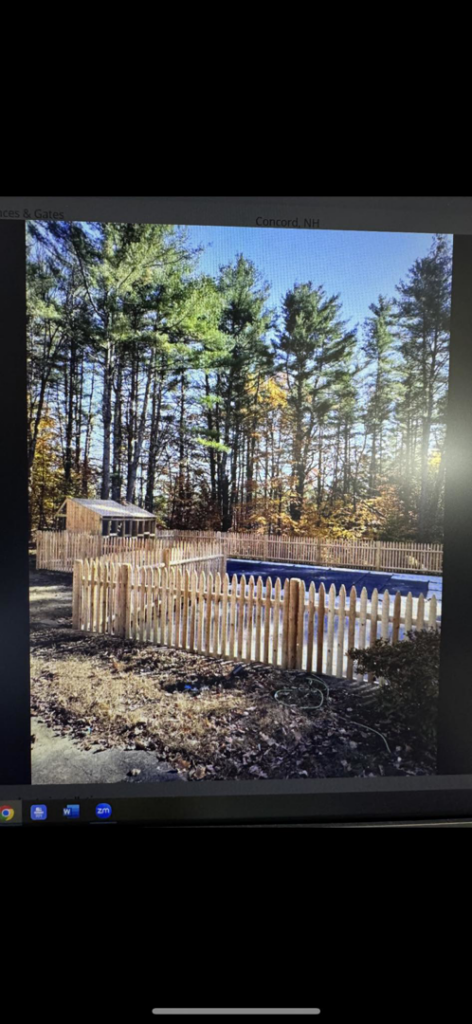 A newly installed picket fence surrounding a pool and shed by Fence Masters NH in Concord, NH.