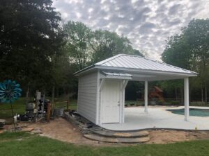 Newly constructed pool house with a covered patio area next to a swimming pool by SRP construction in Houston, TX