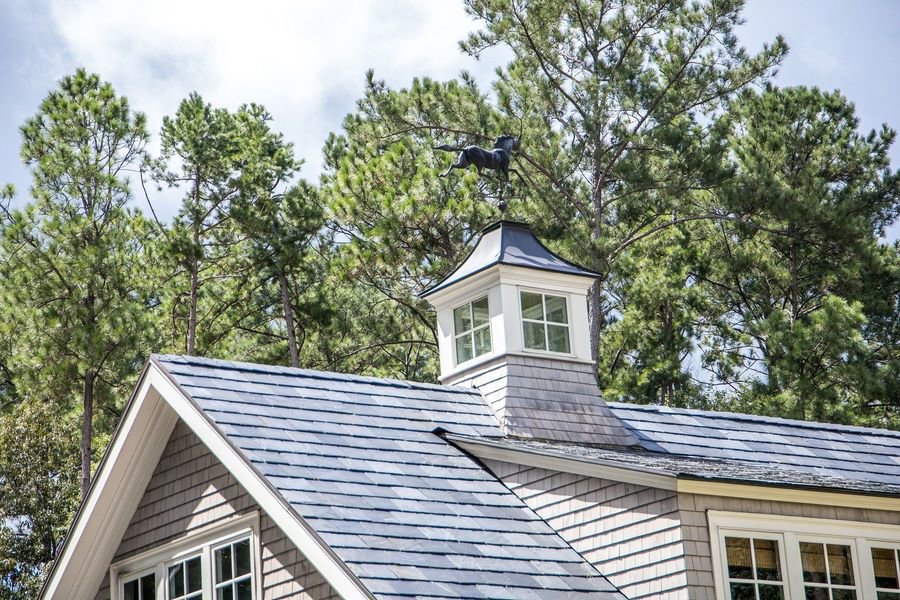 A close-up of a newly installed roof with a decorative cupola and weather vane by Eagle Exteriors in Cumberland, RI.