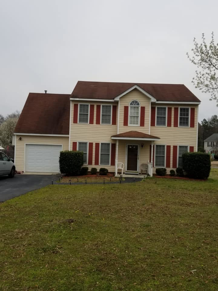 A newly installed brown roof on a residential house, showcasing completed work by Professional Contractor RVA in Richmond, VA.
