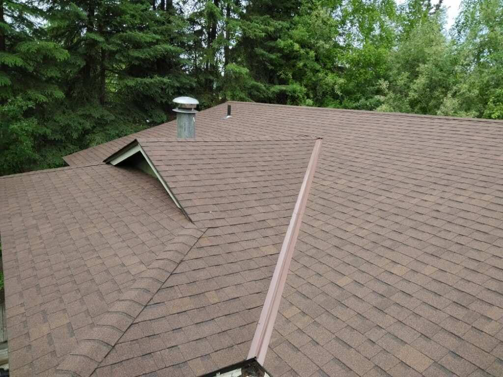 A newly installed brown shingle roof on a house by Fairbanks Finest Handyman in Fairbanks, AK.