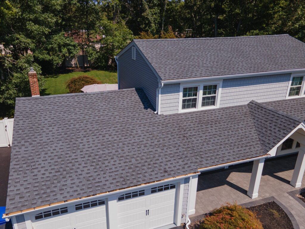 An aerial view of a home with a newly installed gray shingle roof by Stanley Contracting in Whiting, NJ