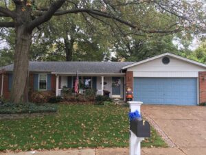 A residential home showcasing a new roof installed by Gwen Co in St. Louis, MO.