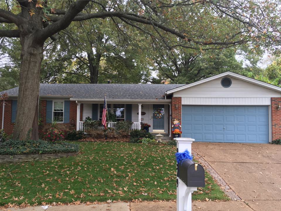 A residential home showcasing a new roof installed by Gwen Co in St. Louis, MO.