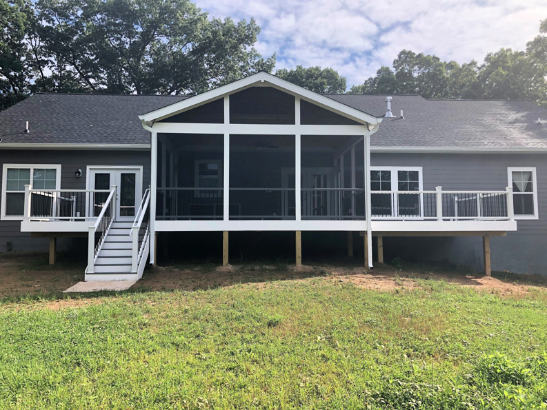 A newly constructed screened porch and deck with stairs leading to the yard by Sundecks, Inc. in Manassas, VA.